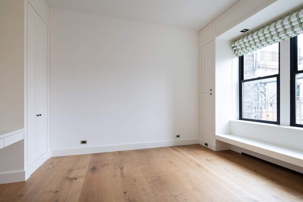 784 Park Avenue, Unit PHC Manhattan, NY 10021 - Photo 10 of 36 an empty room with a window