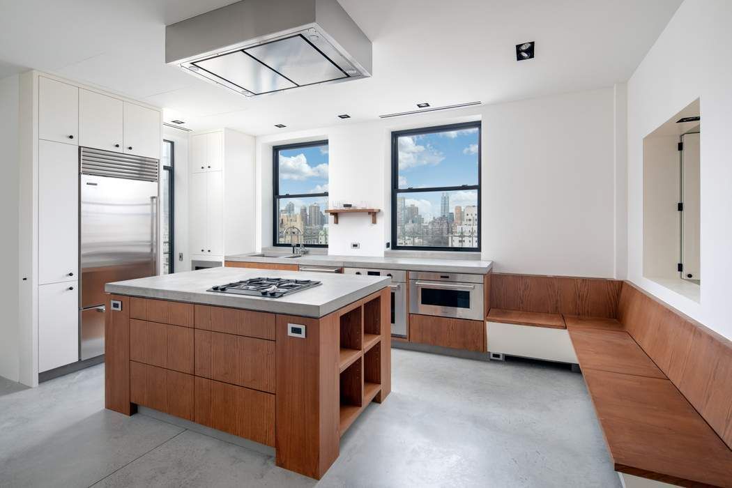 784 Park Avenue, Unit PHC Manhattan, NY 10021 - Photo 4 of 36 a kitchen with a stove and a refrigerator