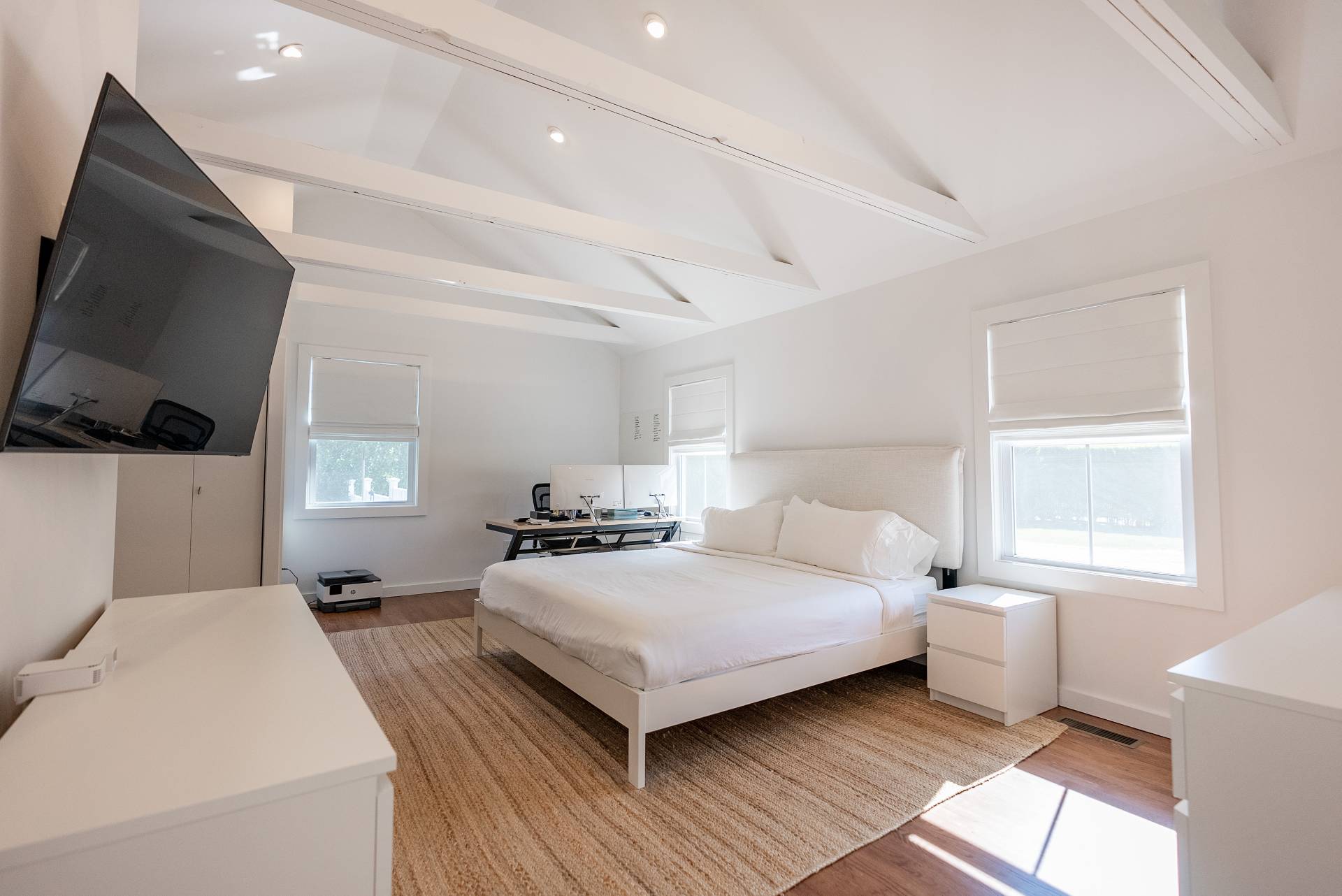 Undisclosed Address Bridgehampton, NY 11932 - Photo 12 of 25 a bedroom with a bed and flat tv screen on the dresser