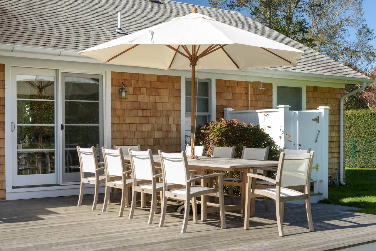Undisclosed Address Bridgehampton, NY 11932 - Photo 16 of 25 a patio with table and chairs