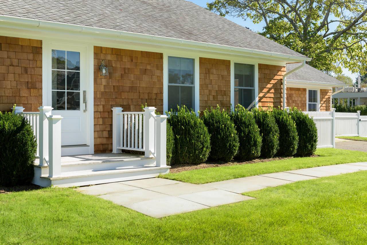 Undisclosed Address Bridgehampton, NY 11932 - Photo 2 of 25 a front view of a house with a garden