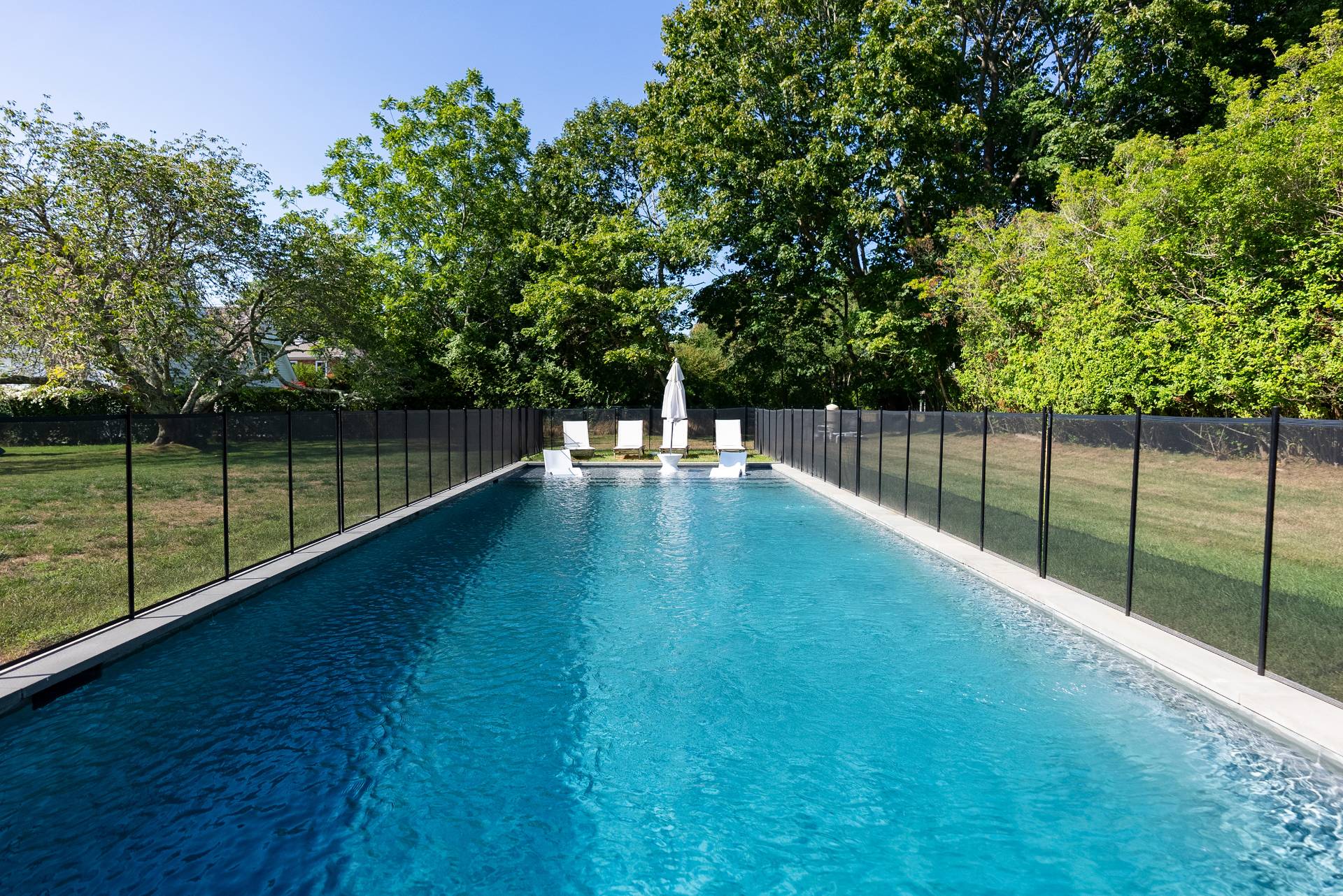 Undisclosed Address Bridgehampton, NY 11932 - Photo 21 of 25 a view of a backyard with a small pool