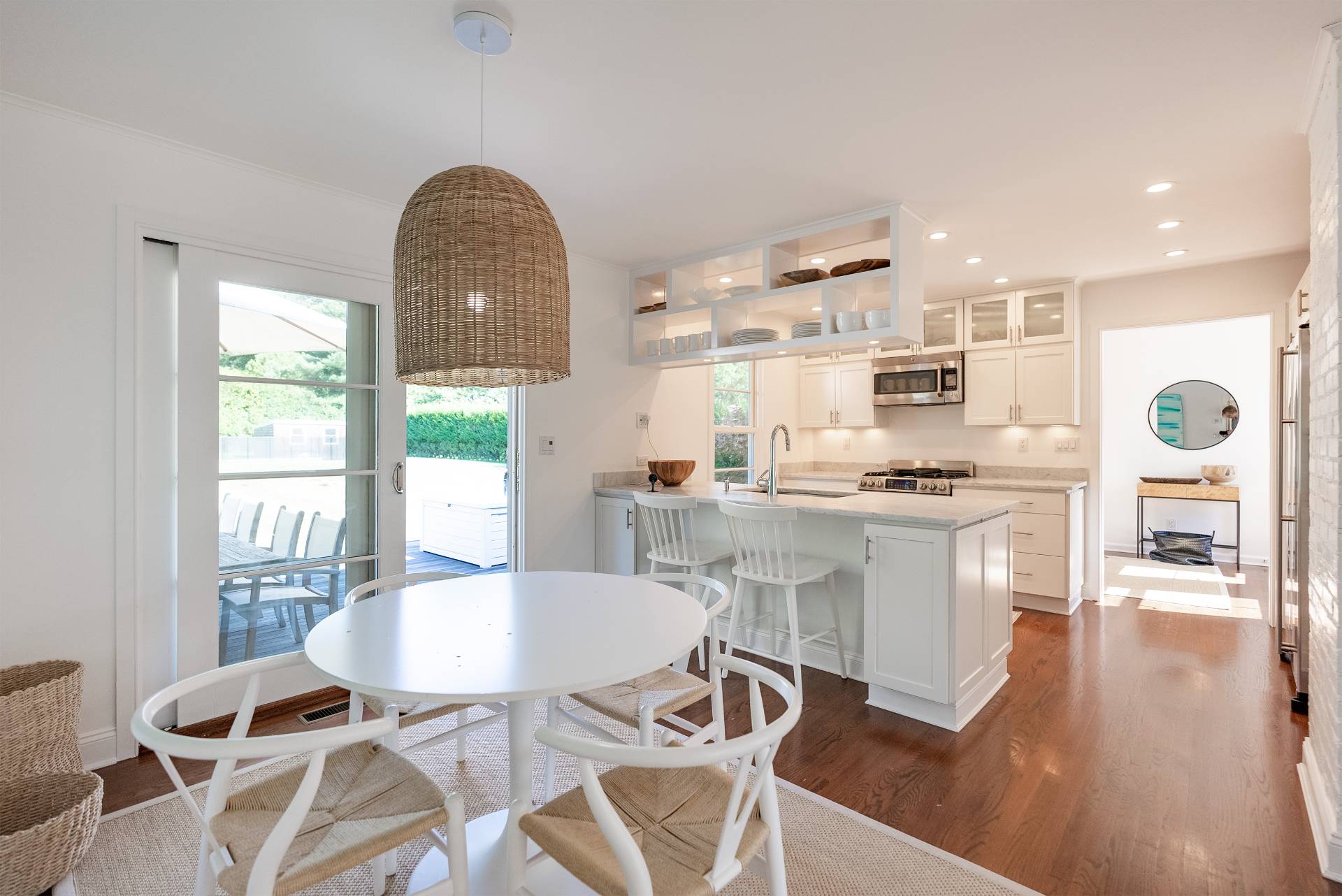 Undisclosed Address Bridgehampton, NY 11932 - Photo 8 of 25 a kitchen with a table chairs and a wooden floor