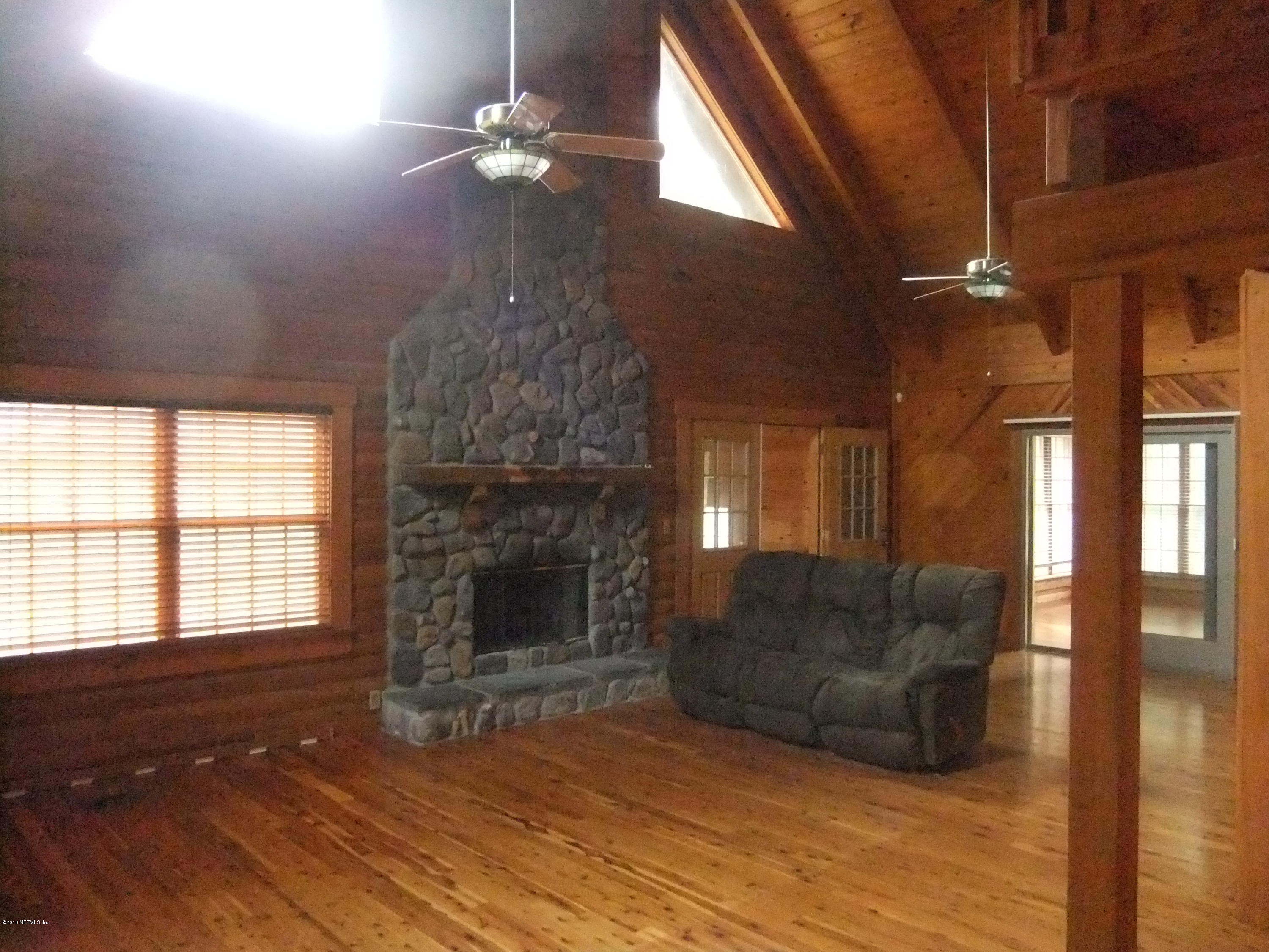 1700 Lake Road Jacksonville, FL 32226 - Photo 11 of 46 a living room with furniture a fireplace and a chandelier