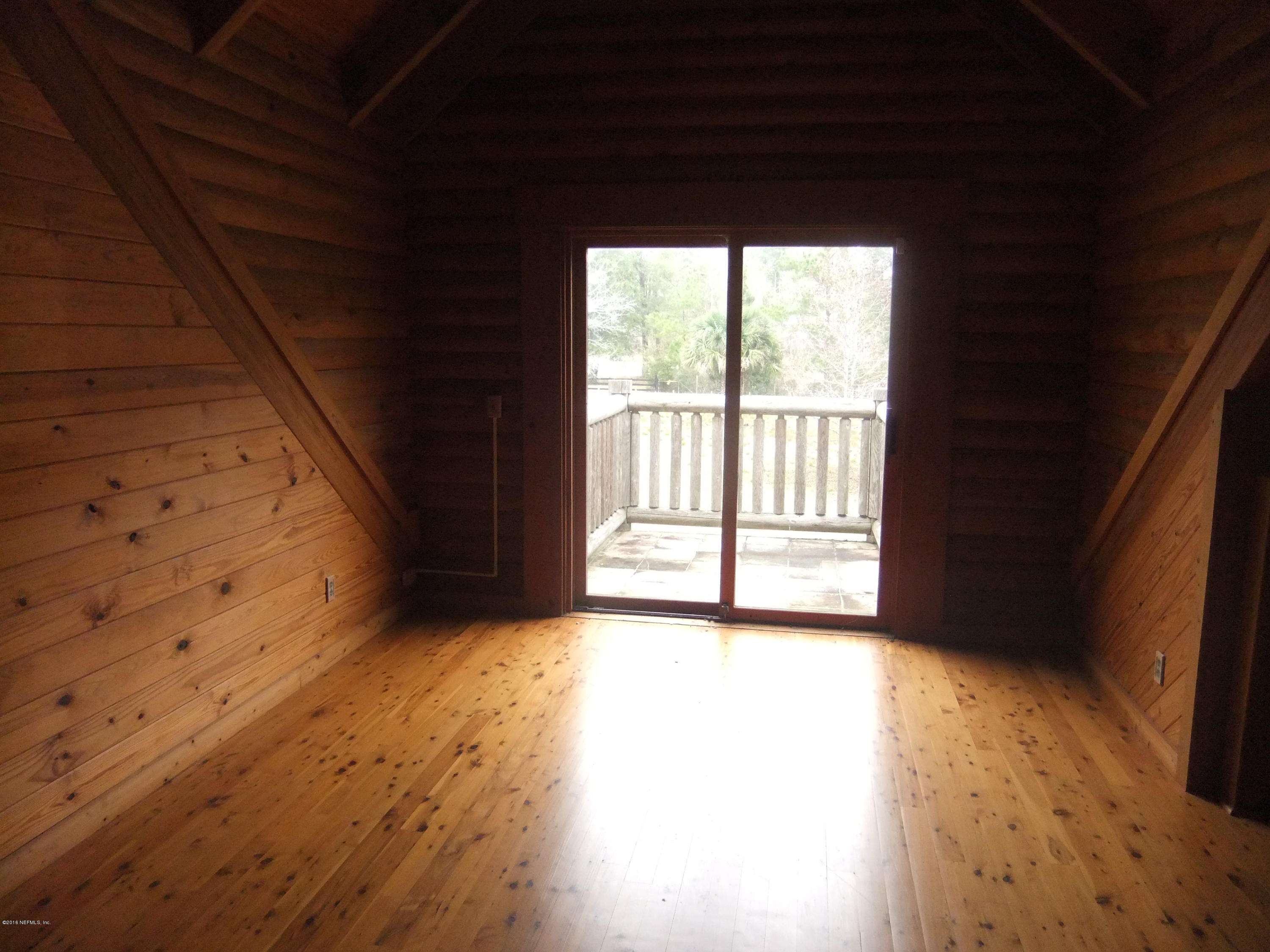 1700 Lake Road Jacksonville, FL 32226 - Photo 16 of 46 a view of an empty room with wooden floor and a window