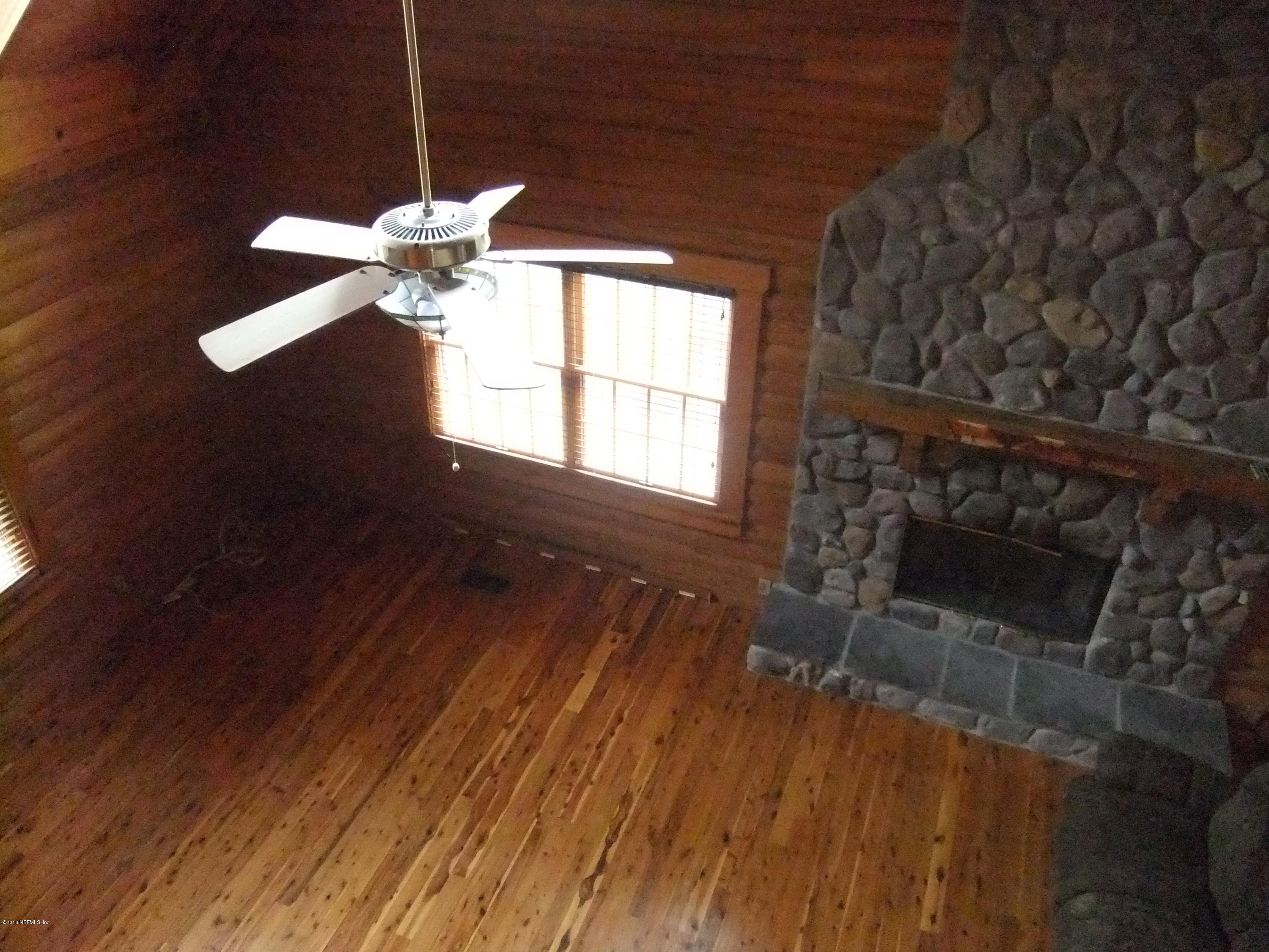 1700 Lake Road Jacksonville, FL 32226 - Photo 18 of 46 a view of an empty room with wooden floor and a fireplace