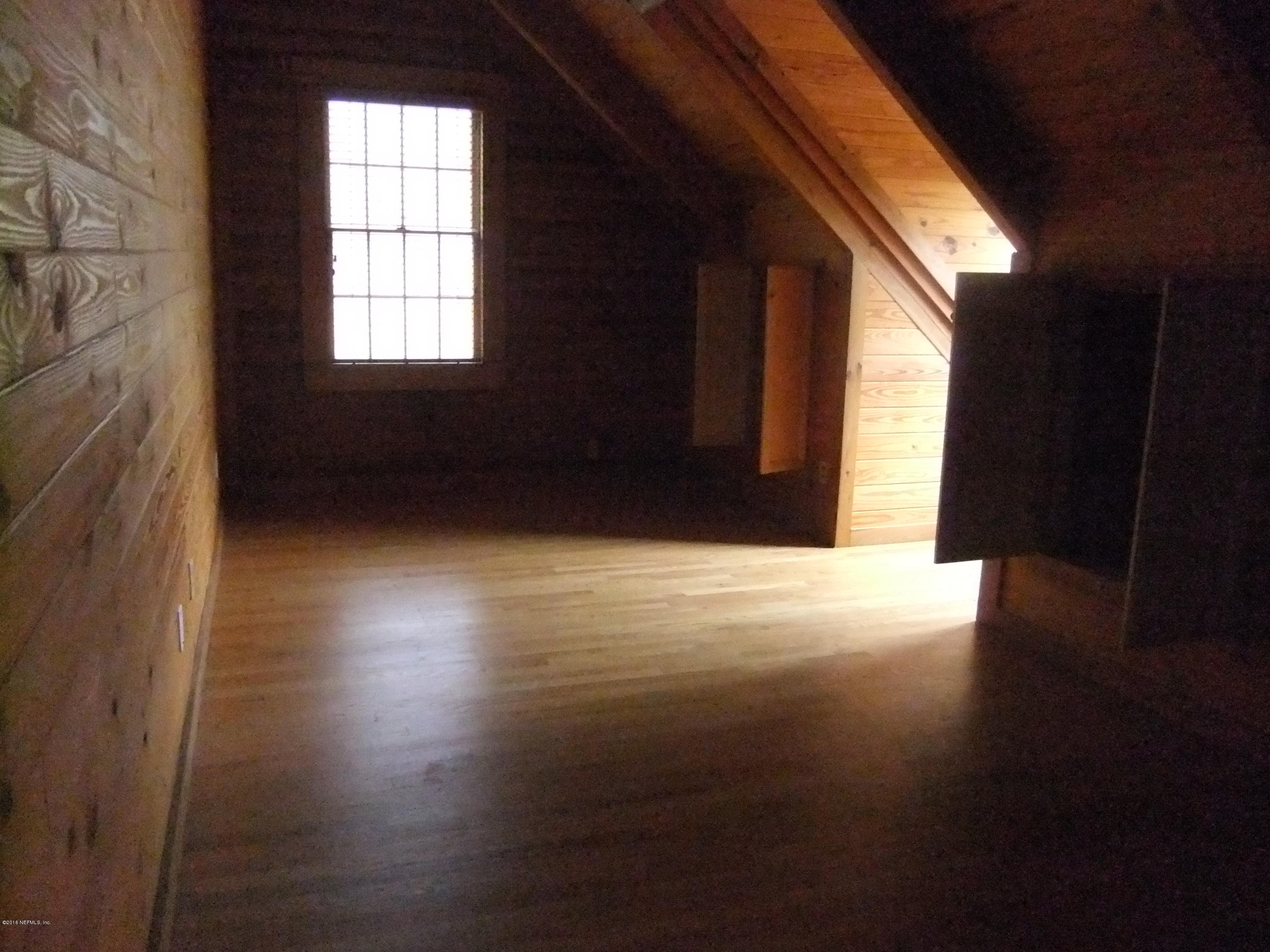 1700 Lake Road Jacksonville, FL 32226 - Photo 19 of 46 a view of an empty room with wooden floor and a window