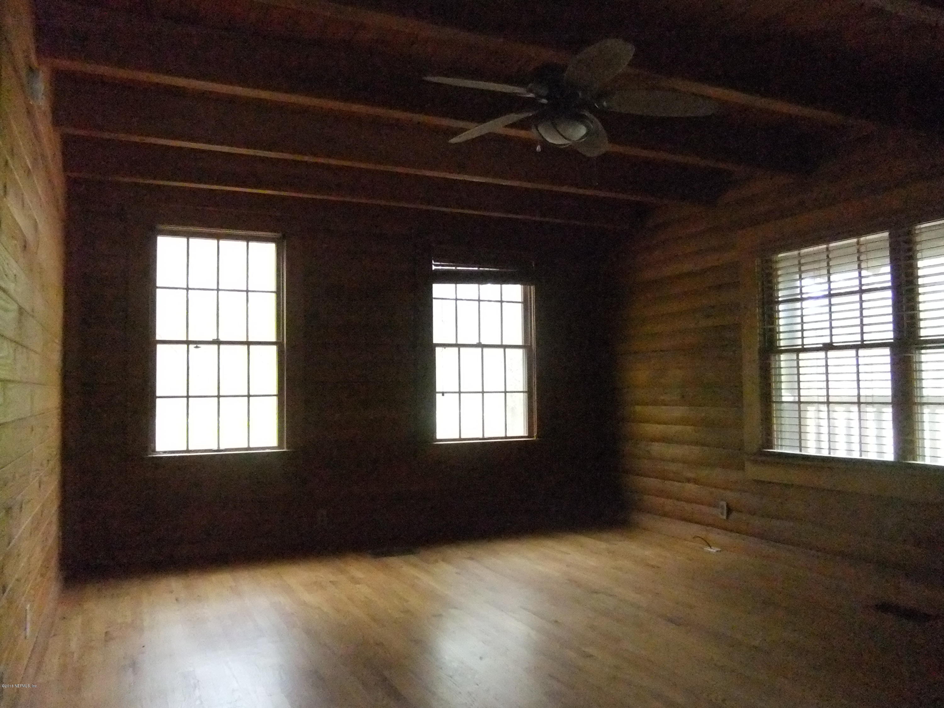 1700 Lake Road Jacksonville, FL 32226 - Photo 22 of 46 a view of an empty room with a window and wooden floor