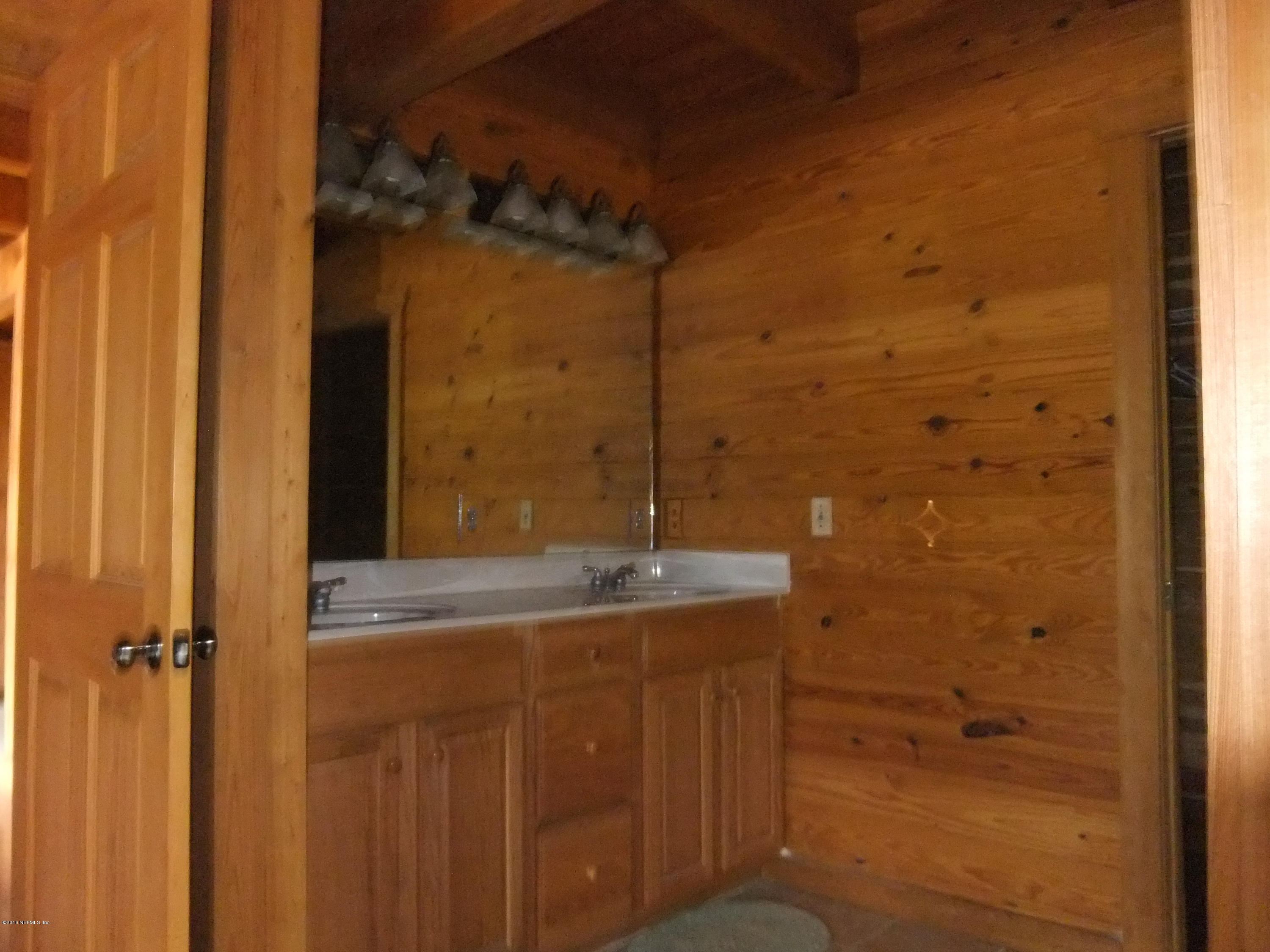 1700 Lake Road Jacksonville, FL 32226 - Photo 24 of 46 a bathroom with a granite countertop sink and a mirror
