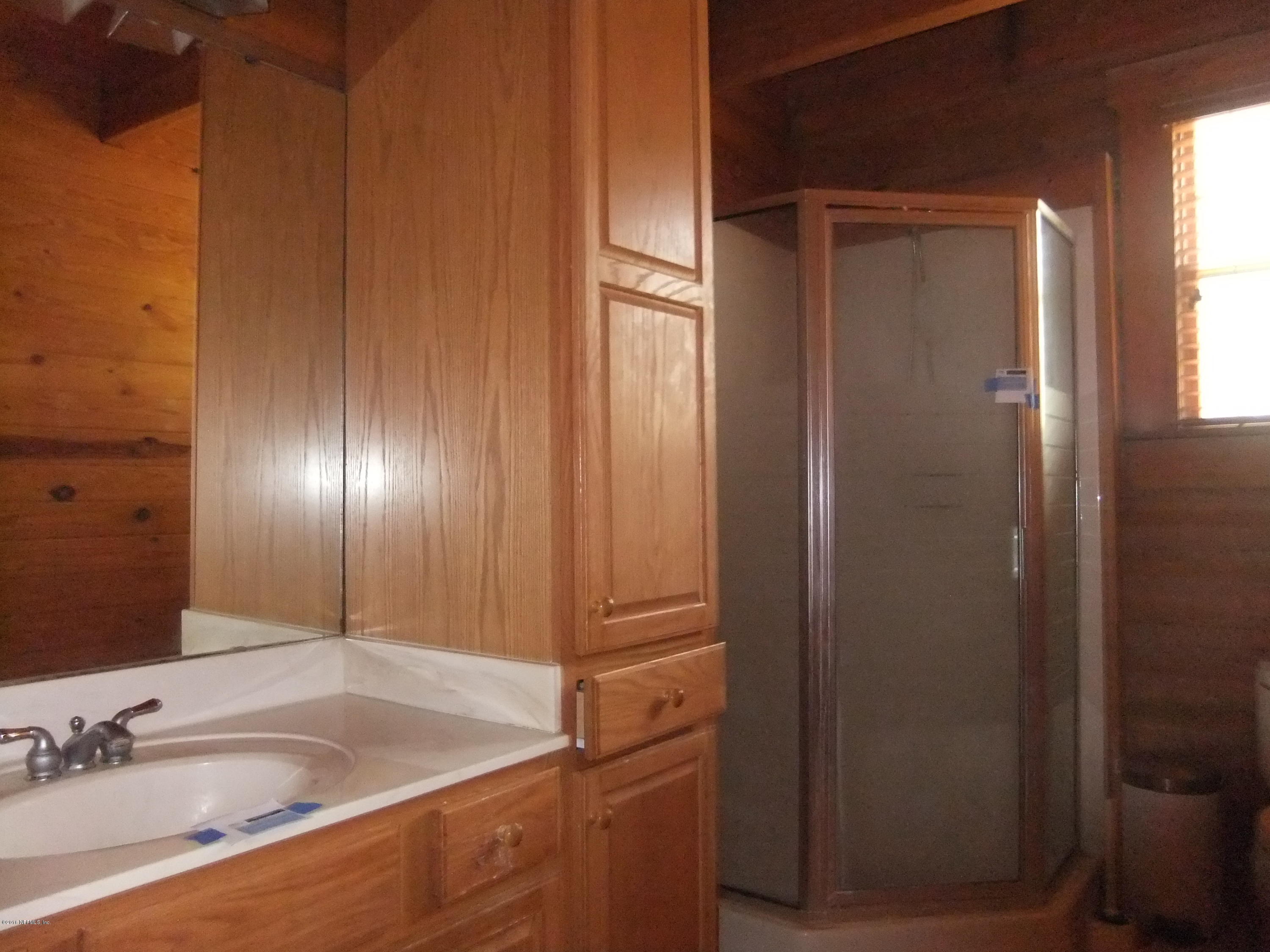 1700 Lake Road Jacksonville, FL 32226 - Photo 6 of 46 a bathroom with a sink and a large mirror