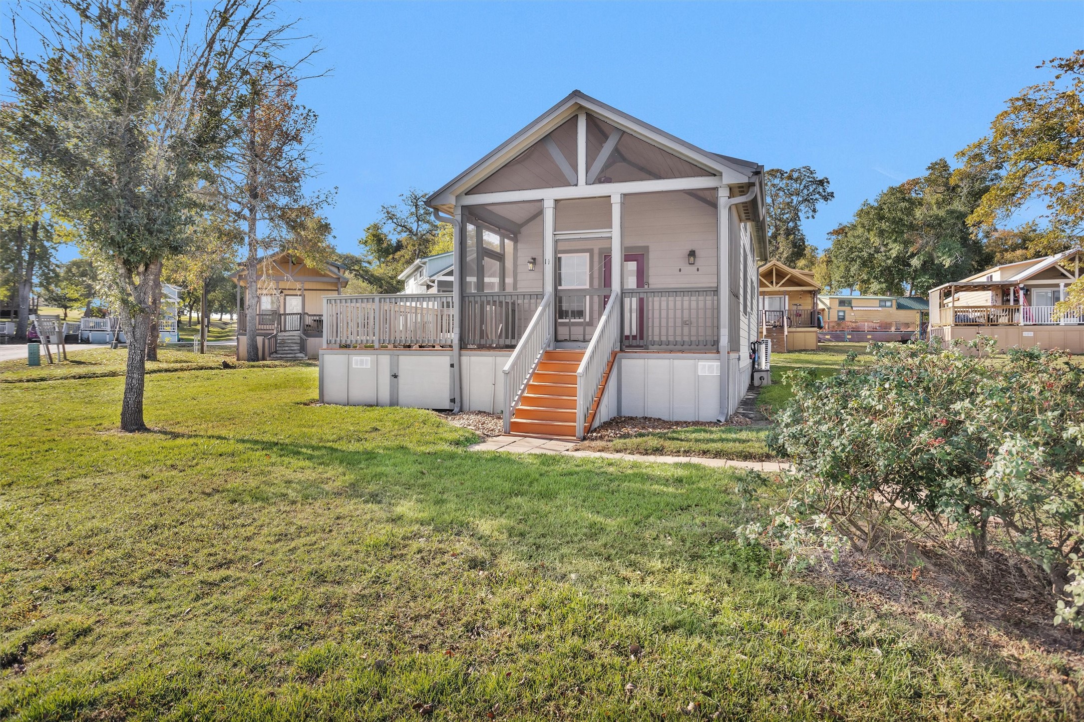 a view of a house with a yard and tree s