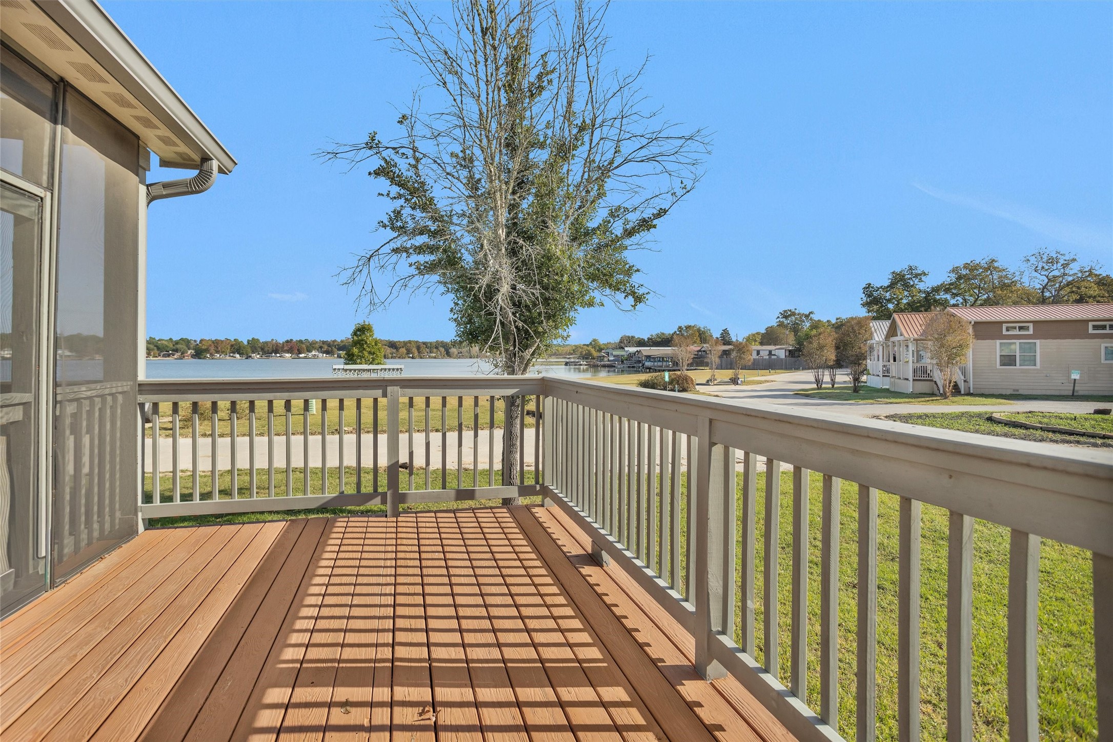 12922 Longstreet Road, Unit 711 Willis, TX 77318 - Photo 20 of 29 a view of a balcony with wooden floor and fence