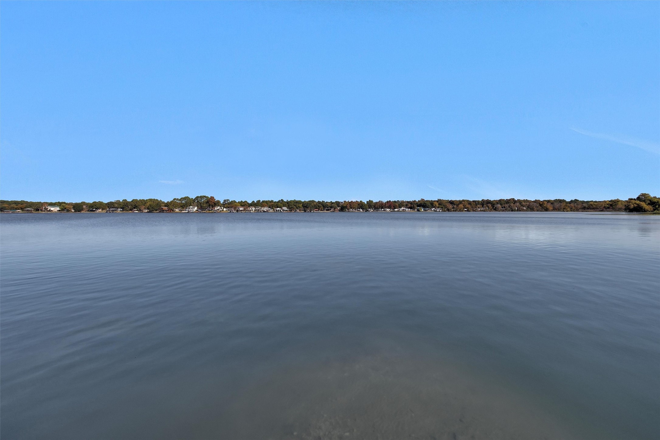 12922 Longstreet Road, Unit 711 Willis, TX 77318 - Photo 26 of 29 a view of a lake with a city