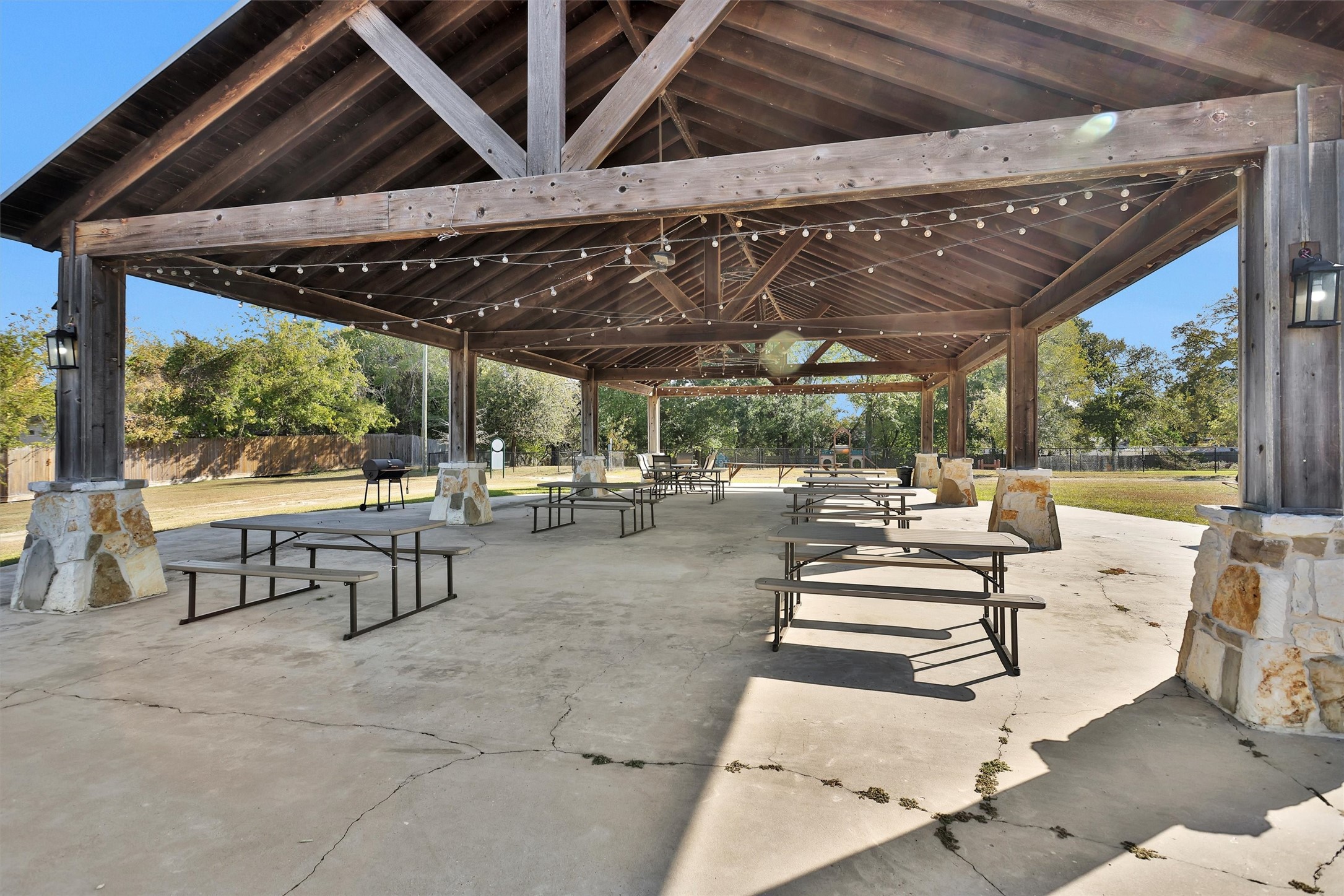12922 Longstreet Road, Unit 711 Willis, TX 77318 - Photo 27 of 29 a view of a patio with table and chairs potted plants with large glass windows
