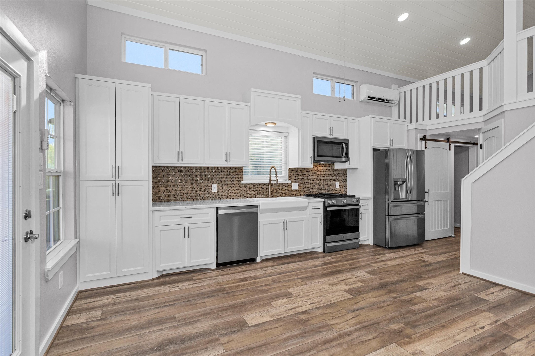 12922 Longstreet Road, Unit 711 Willis, TX 77318 - Photo 7 of 29 a kitchen with a refrigerator and a stove top oven