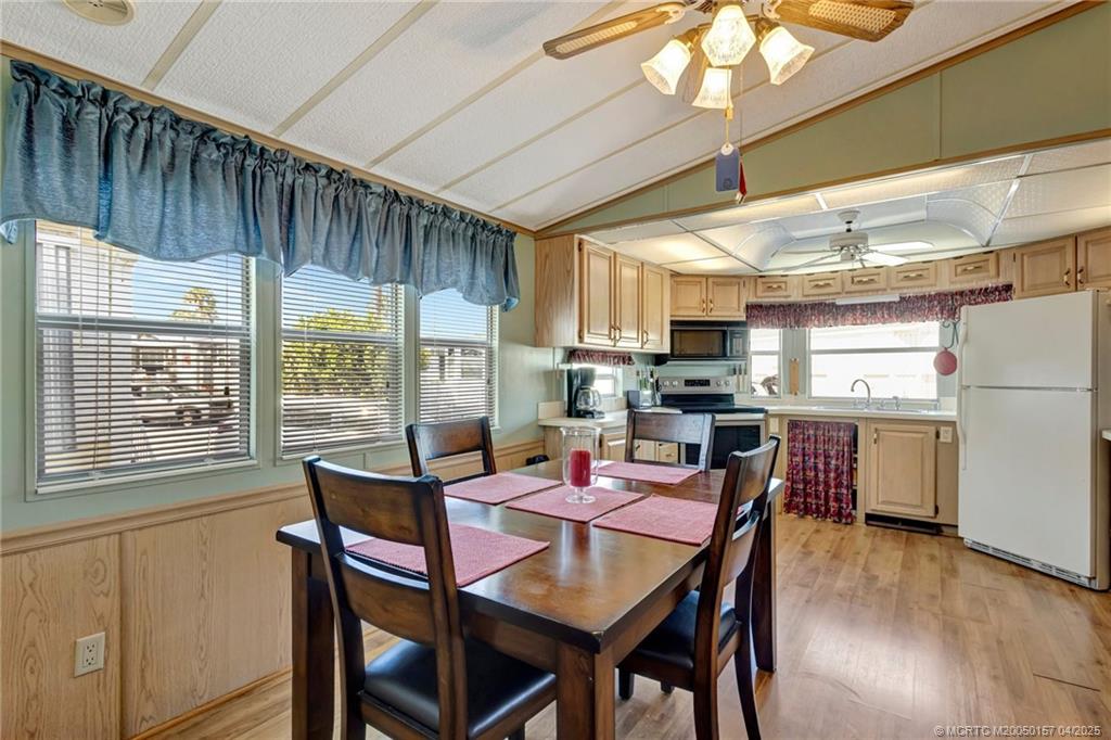 10725 South Ocean Drive, Unit 437 Jensen Beach, FL 34957 - Photo 13 of 32 a view of a dining room with furniture window and wooden floor