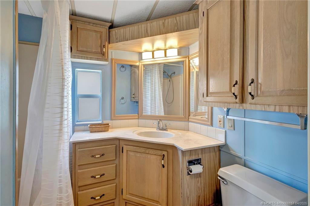 10725 South Ocean Drive, Unit 437 Jensen Beach, FL 34957 - Photo 16 of 32 a bathroom with a sink and a toilet