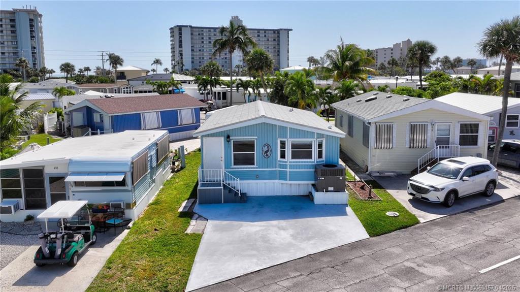 10725 South Ocean Drive, Unit 437 Jensen Beach, FL 34957 - Photo 2 of 32 a aerial view of a house with swimming pool and glass doors