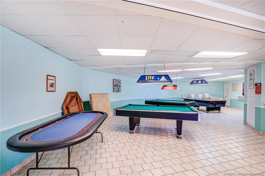 10725 South Ocean Drive, Unit 437 Jensen Beach, FL 34957 - Photo 26 of 32 a room with furniture and air hockey table