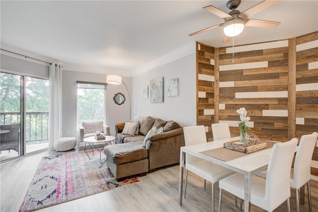 1 Biscayne Drive Northwest, Unit 309 Atlanta, GA 30309 - Photo 1 of 1 a living room with furniture and a large window