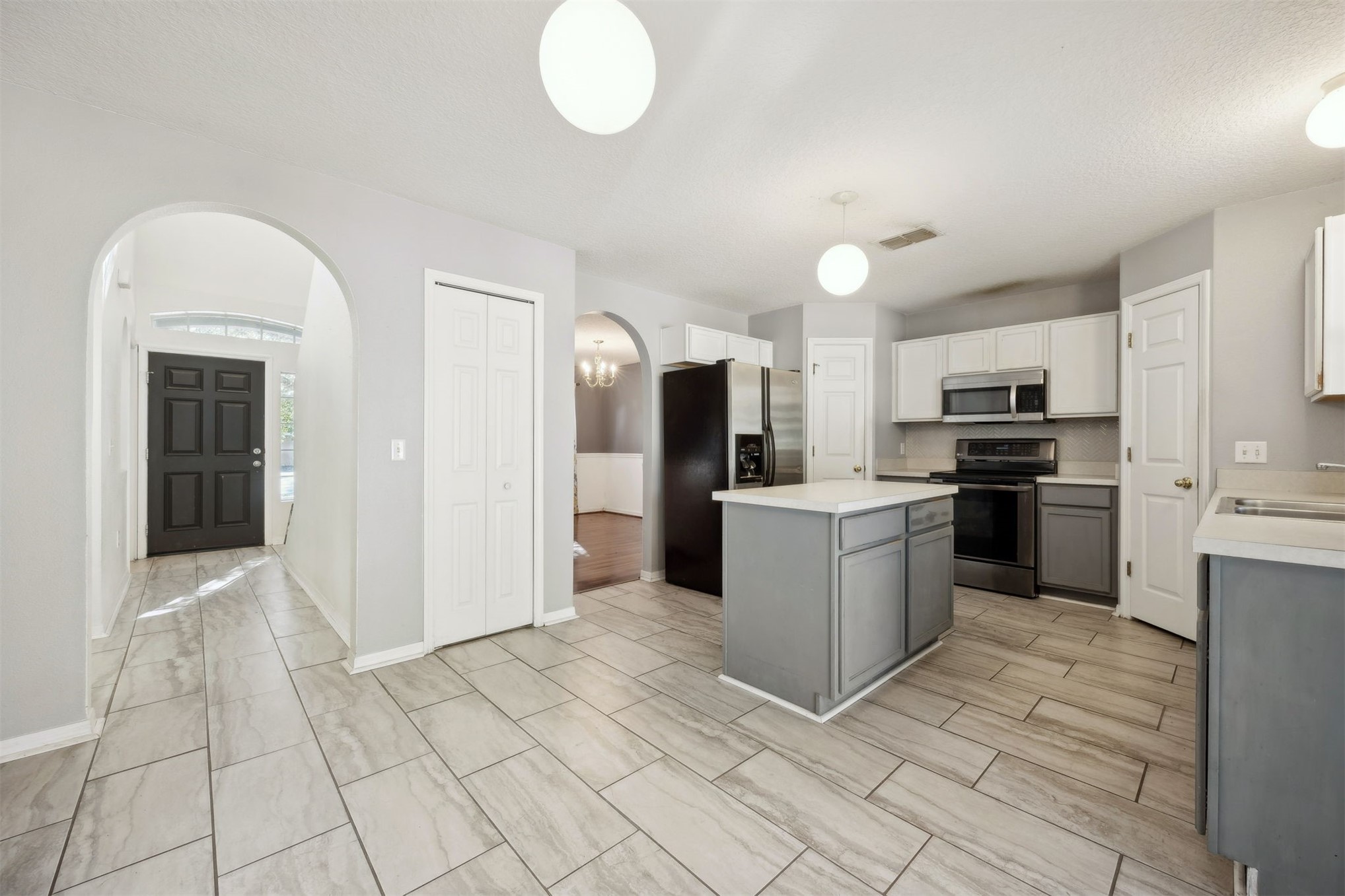 87233 Kipling Drive Yulee, FL 32097 - Photo 12 of 38 a kitchen with granite countertop a refrigerator and a stove top oven