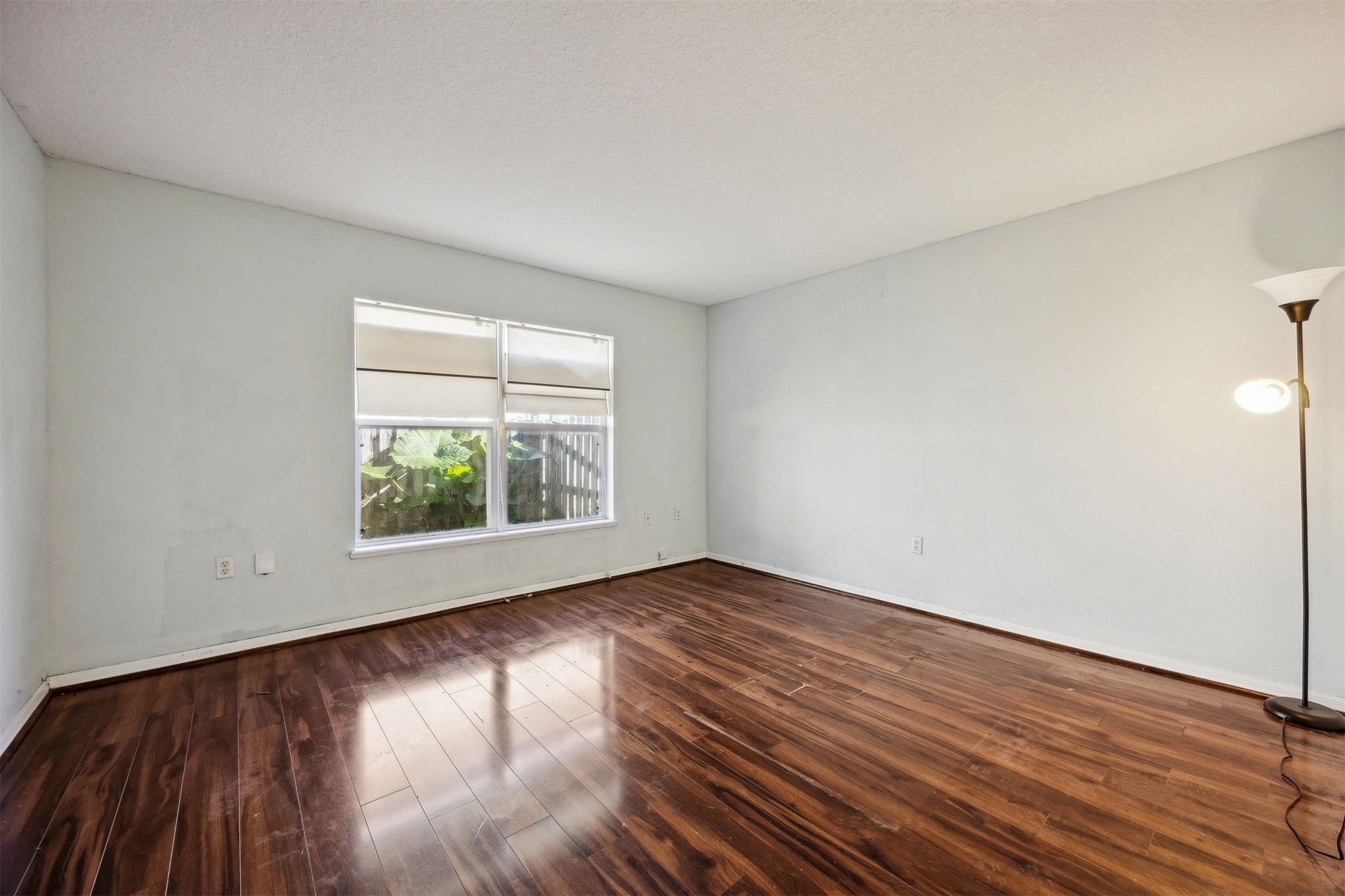 87233 Kipling Drive Yulee, FL 32097 - Photo 17 of 38 an empty room with wooden floor and windows