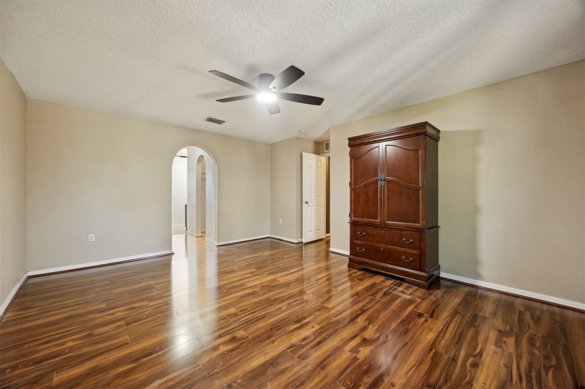 87233 Kipling Drive Yulee, FL 32097 - Photo 23 of 38 a view of empty room with wooden floor and fan
