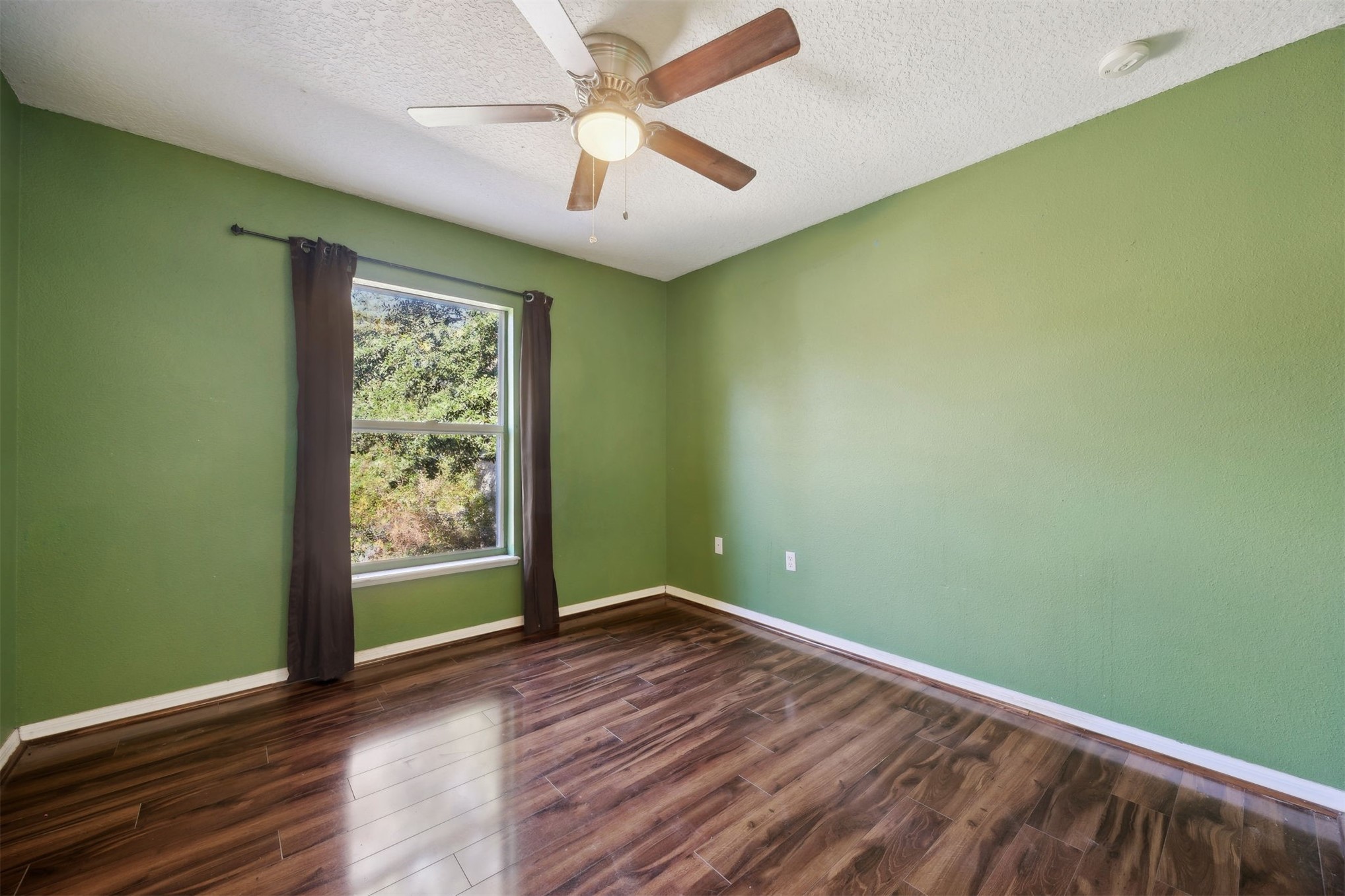 87233 Kipling Drive Yulee, FL 32097 - Photo 30 of 38 an empty room with wooden floor and windows