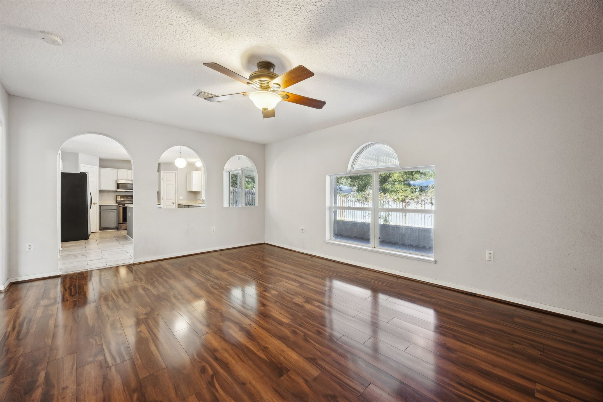 87233 Kipling Drive Yulee, FL 32097 - Photo 4 of 38 a view of an empty room with wooden floor and a window