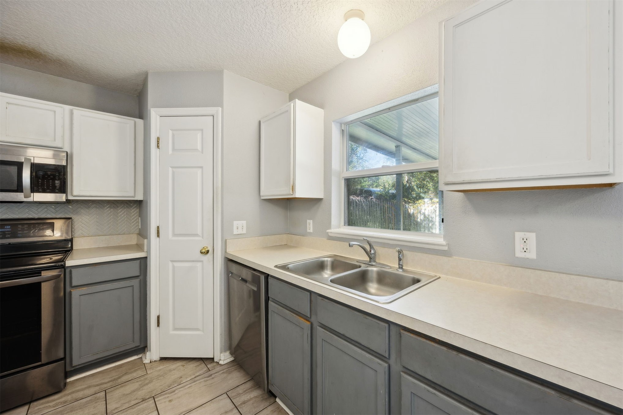 87233 Kipling Drive Yulee, FL 32097 - Photo 9 of 38 a kitchen with a sink cabinets and window