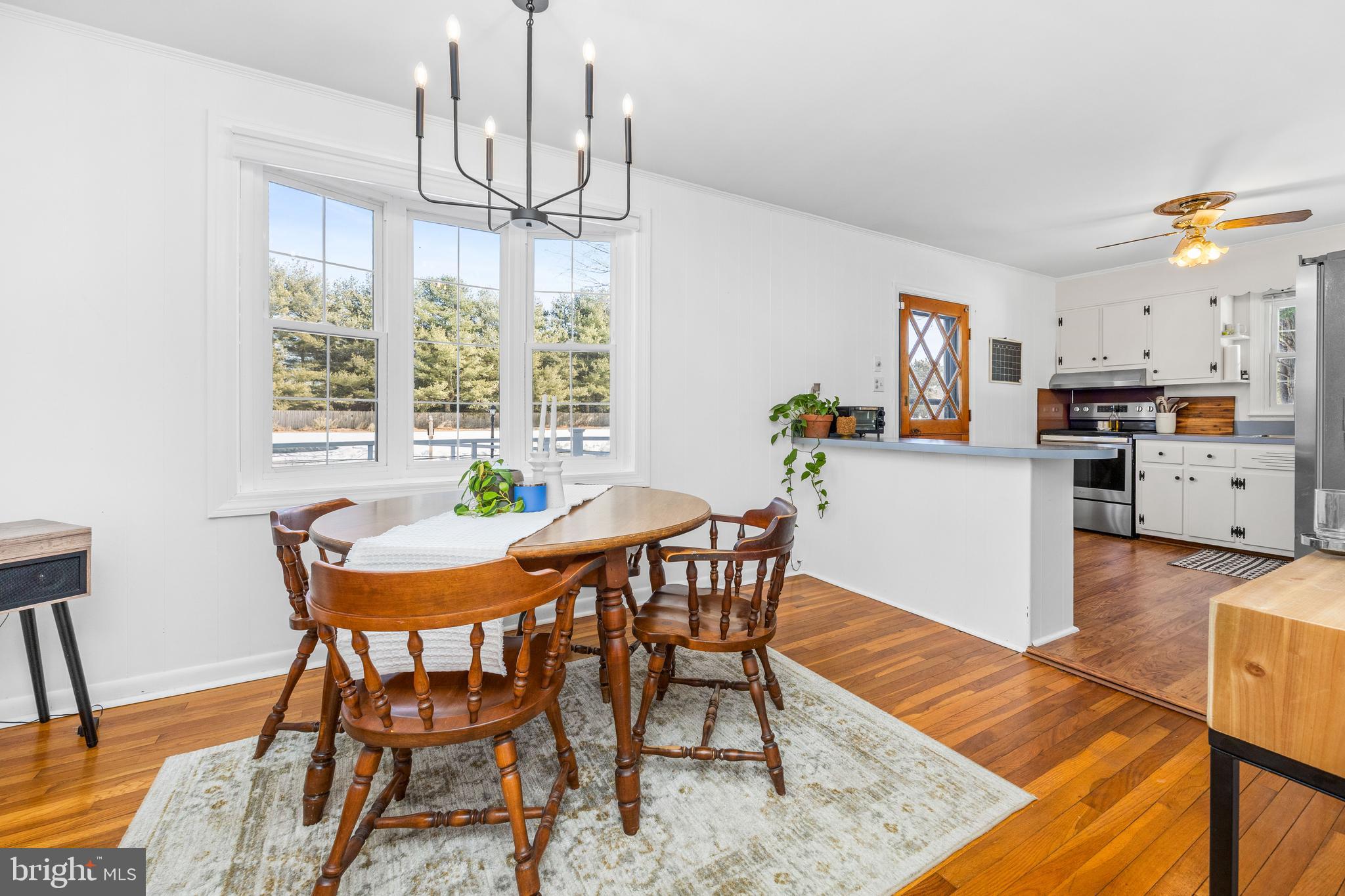 3750 Sunnyside Road East New Market, MD 21631 - Photo 12 of 45 a dining room with furniture a chandelier and wooden floor