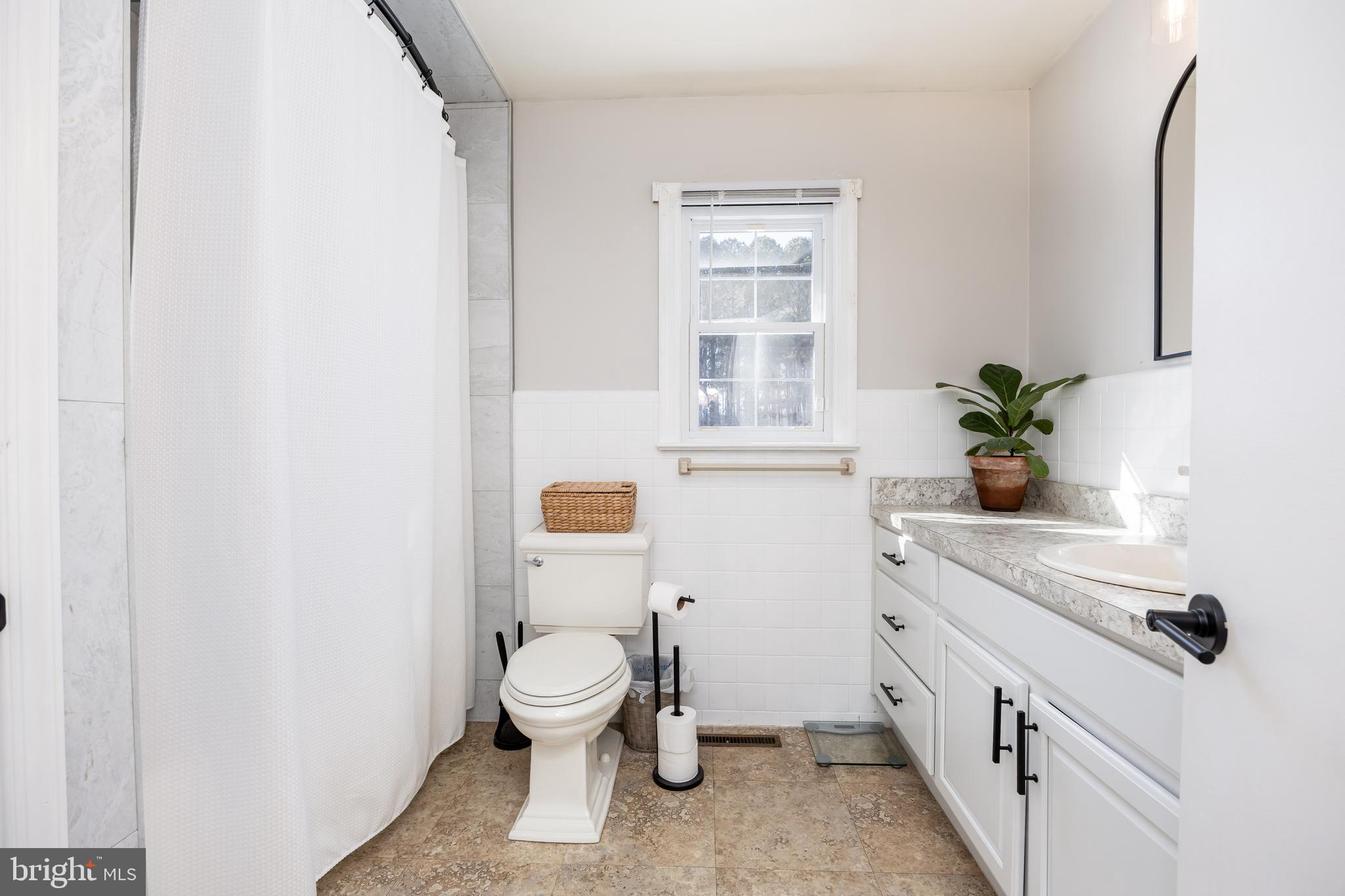 3750 Sunnyside Road East New Market, MD 21631 - Photo 21 of 45 a bathroom with a toilet sink and mirror