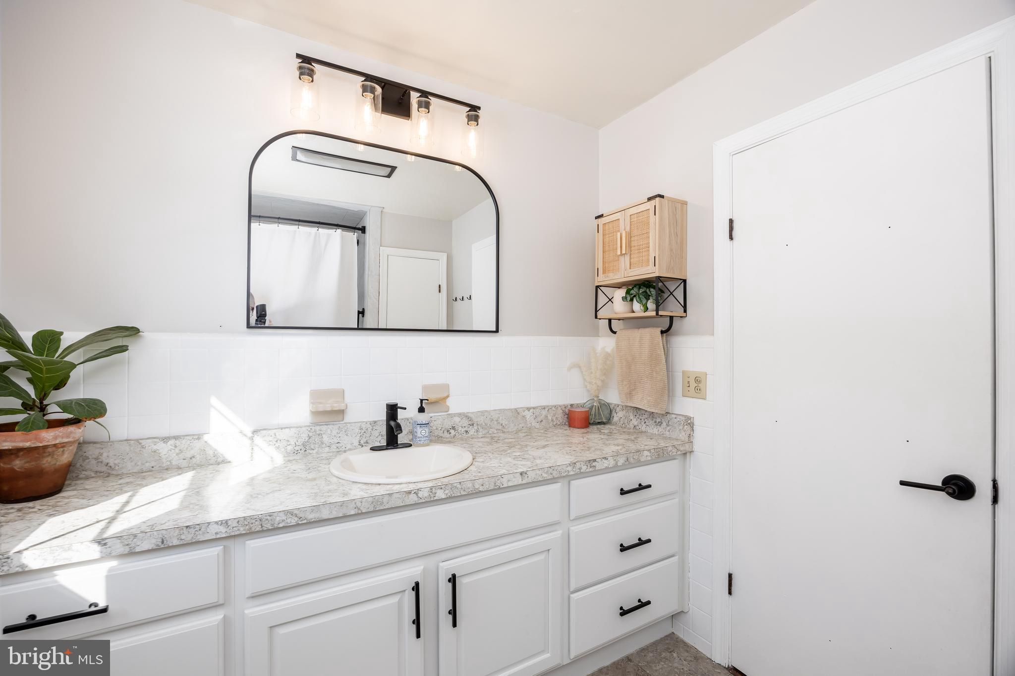 3750 Sunnyside Road East New Market, MD 21631 - Photo 24 of 45 a bathroom with a granite countertop sink and a mirror