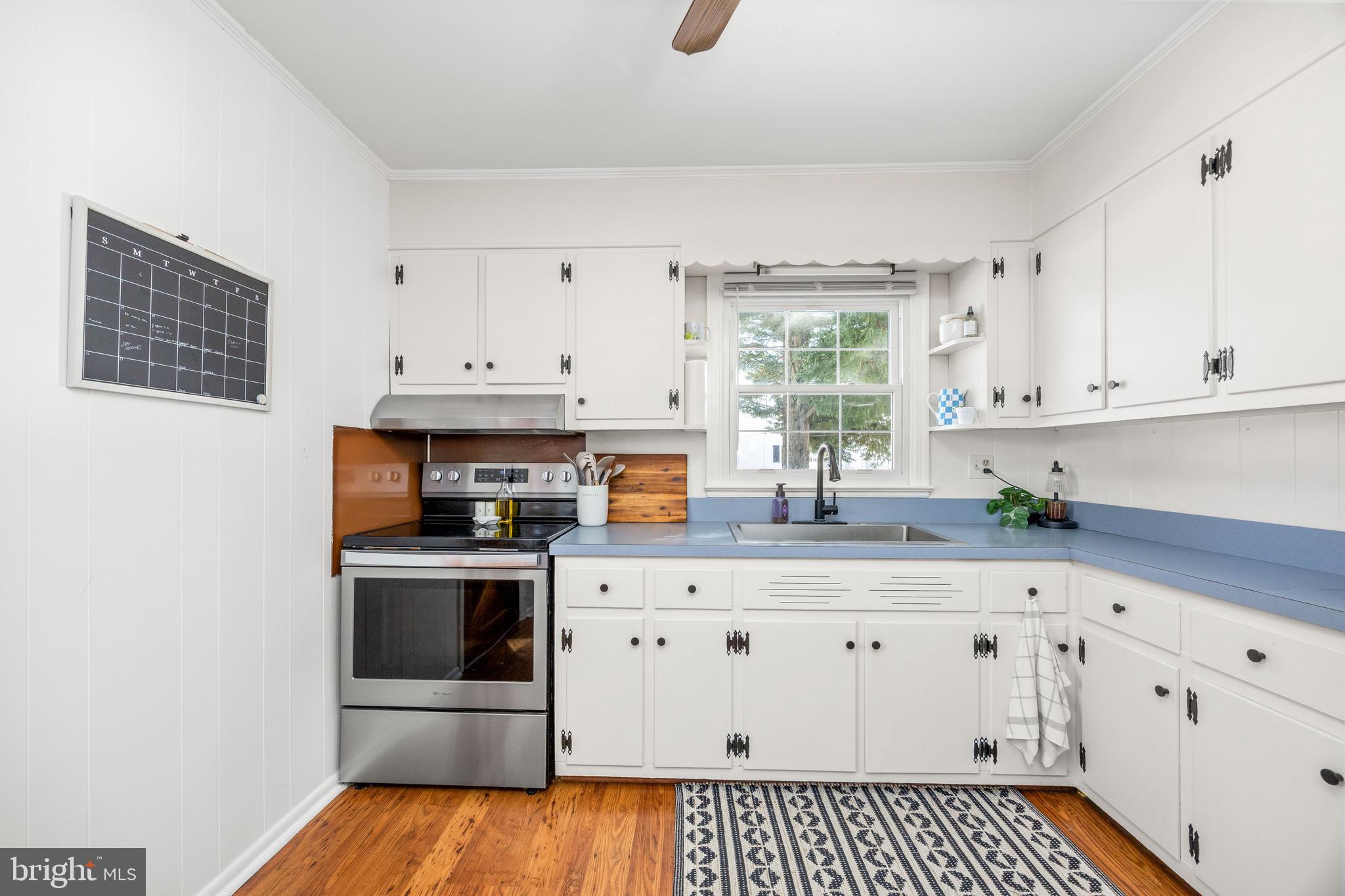 3750 Sunnyside Road East New Market, MD 21631 - Photo 6 of 45 a kitchen with granite countertop white cabinets and white appliances
