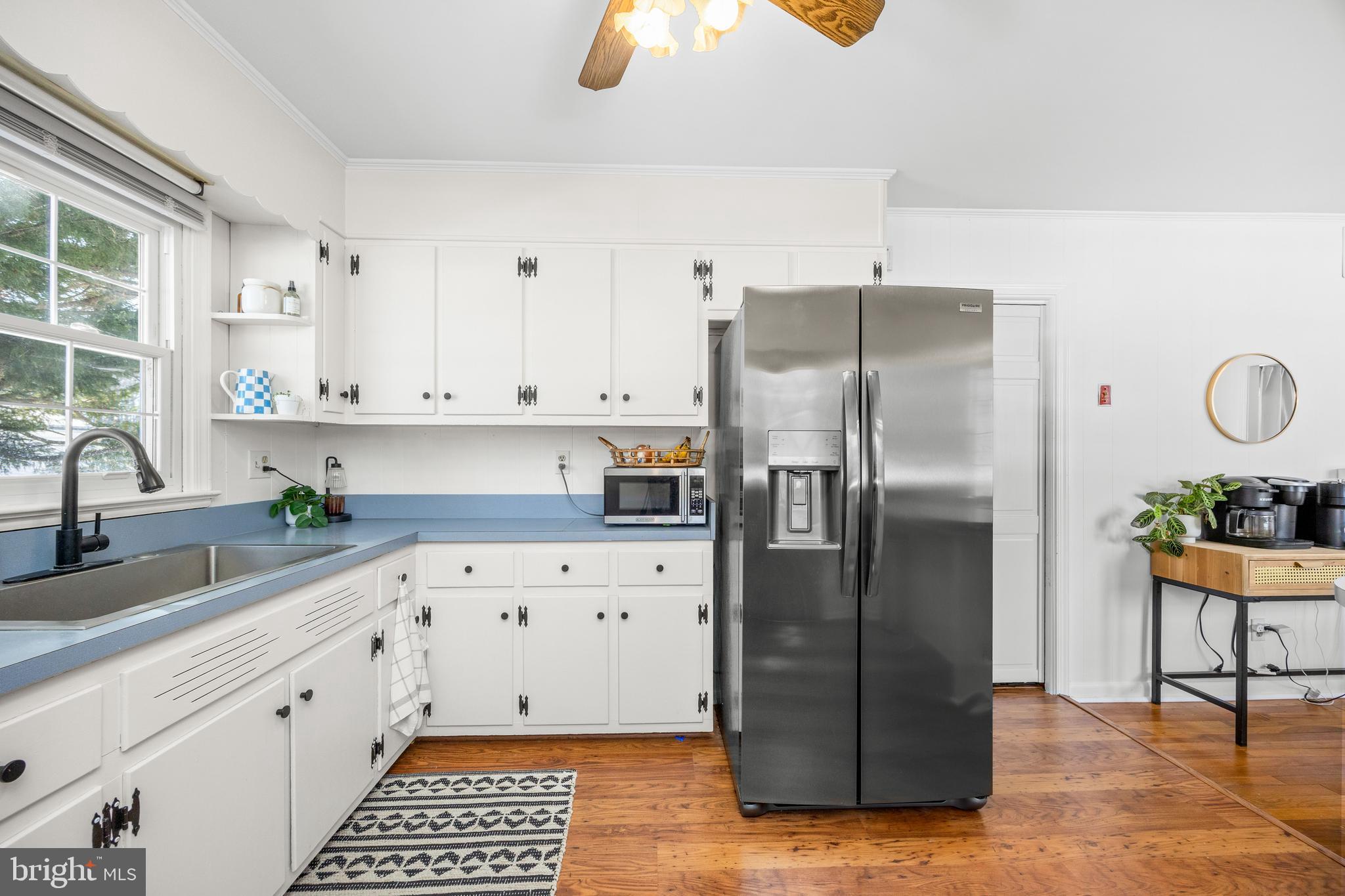 3750 Sunnyside Road East New Market, MD 21631 - Photo 7 of 45 a kitchen with stainless steel appliances granite countertop a refrigerator a stove a sink and dishwasher with wooden floor