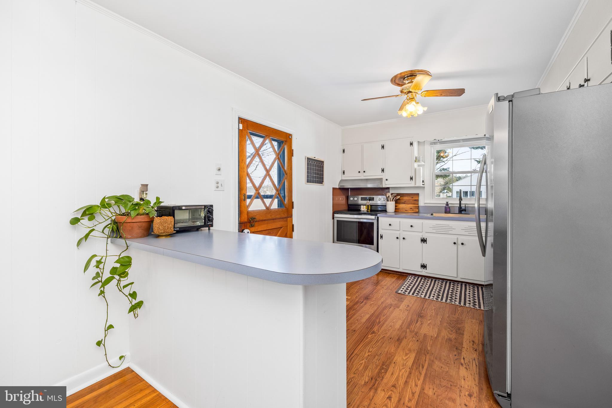 3750 Sunnyside Road East New Market, MD 21631 - Photo 10 of 45 a kitchen with stainless steel appliances a refrigerator a stove a microwave a sink and a potted plant