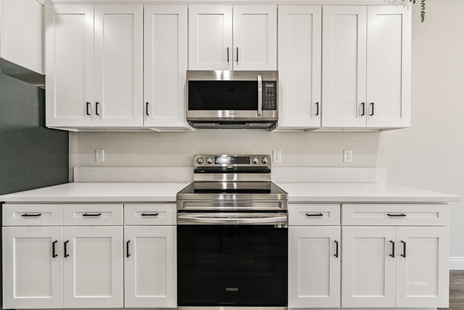 1031 West Church Avenue Ridgecrest, CA 93555 - Photo 7 of 49 a kitchen with white cabinets and black appliances