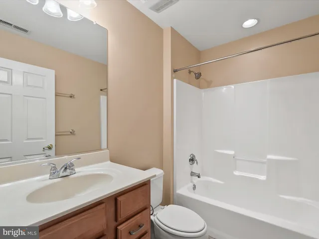 a view of swimming pool with lawn chairs under an umbrella