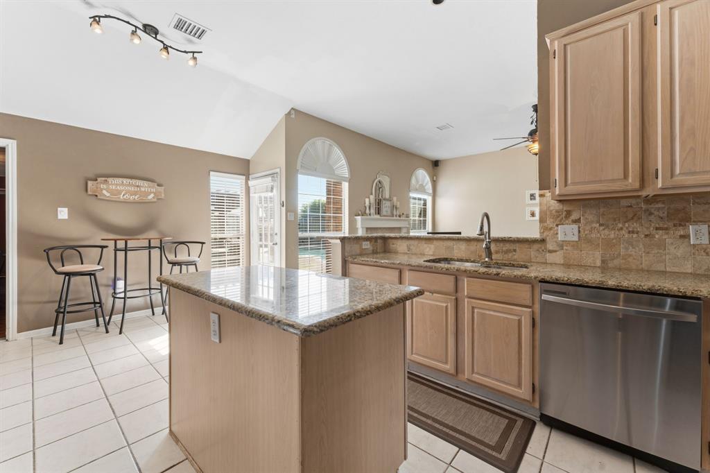706 Sycamore Creek Road Allen, TX 75002 - Photo 11 of 28 a kitchen with stainless steel appliances granite countertop a sink and cabinets