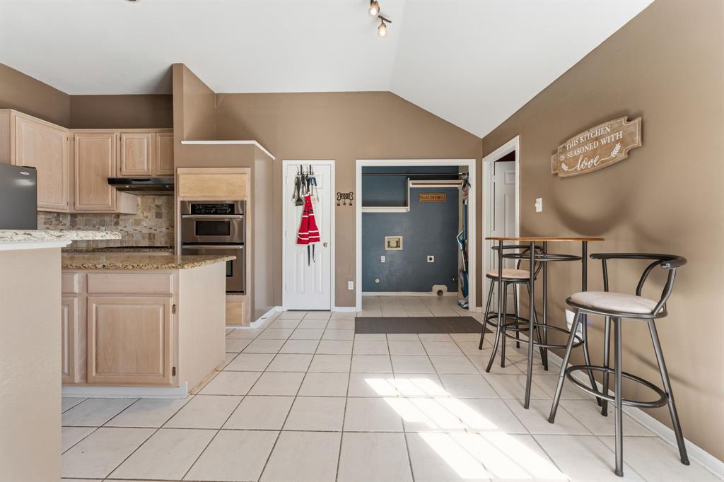 706 Sycamore Creek Road Allen, TX 75002 - Photo 12 of 28 a kitchen with granite countertop a sink cabinets and stainless steel appliances