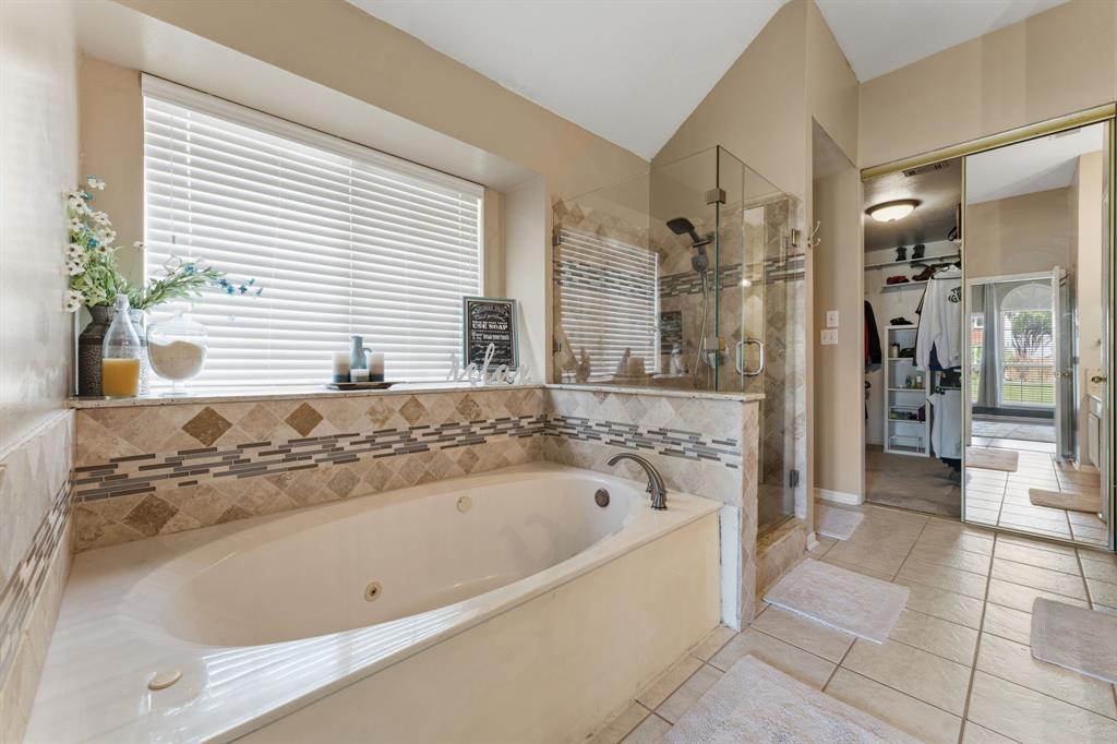 706 Sycamore Creek Road Allen, TX 75002 - Photo 16 of 28 a bathroom with a bathtub and a shower
