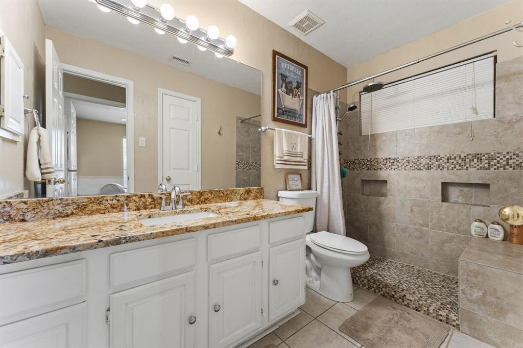 706 Sycamore Creek Road Allen, TX 75002 - Photo 18 of 28 a bathroom with a granite countertop sink toilet and shower