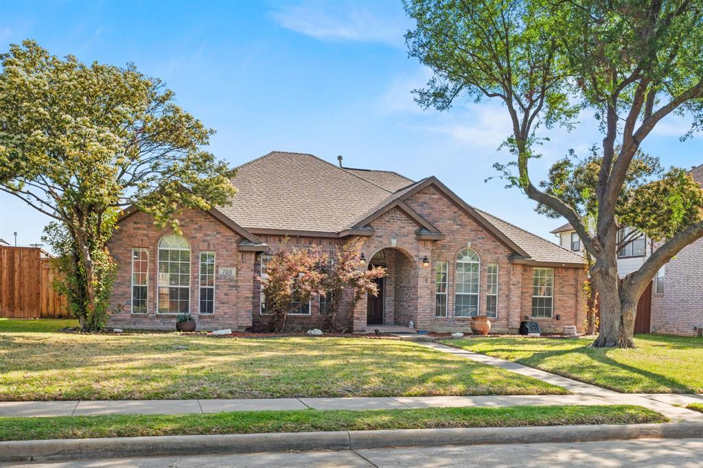 706 Sycamore Creek Road Allen, TX 75002 - Photo 2 of 28 a front view of a house with a garden