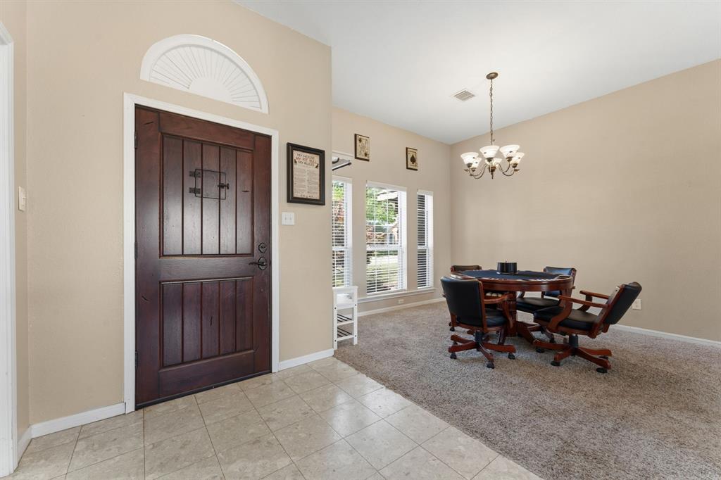 706 Sycamore Creek Road Allen, TX 75002 - Photo 3 of 28 a view of a dining room with furniture and chandelier