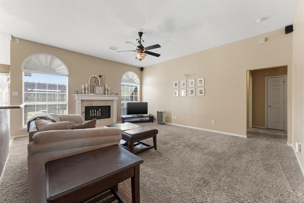 706 Sycamore Creek Road Allen, TX 75002 - Photo 7 of 28 a living room with furniture a fireplace and a flat screen tv