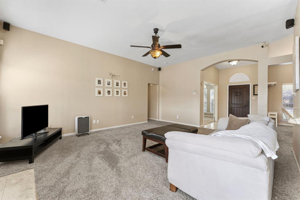 706 Sycamore Creek Road Allen, TX 75002 - Photo 8 of 28 a living room with furniture and a flat screen tv