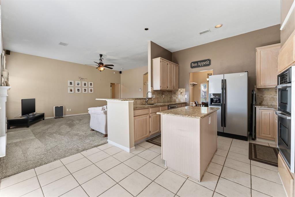 706 Sycamore Creek Road Allen, TX 75002 - Photo 9 of 28 a kitchen with a refrigerator sink and cabinets