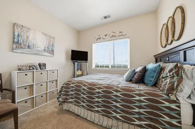 a bedroom with a large bed and a window