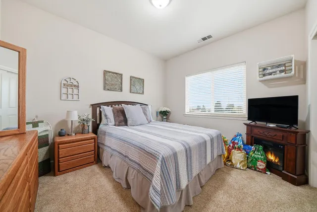 a bedroom with a bed and a flat screen tv