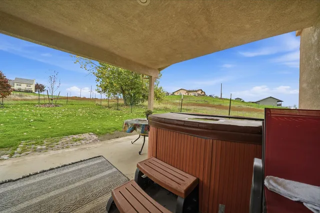 a view of a two chairs and a table in the patio